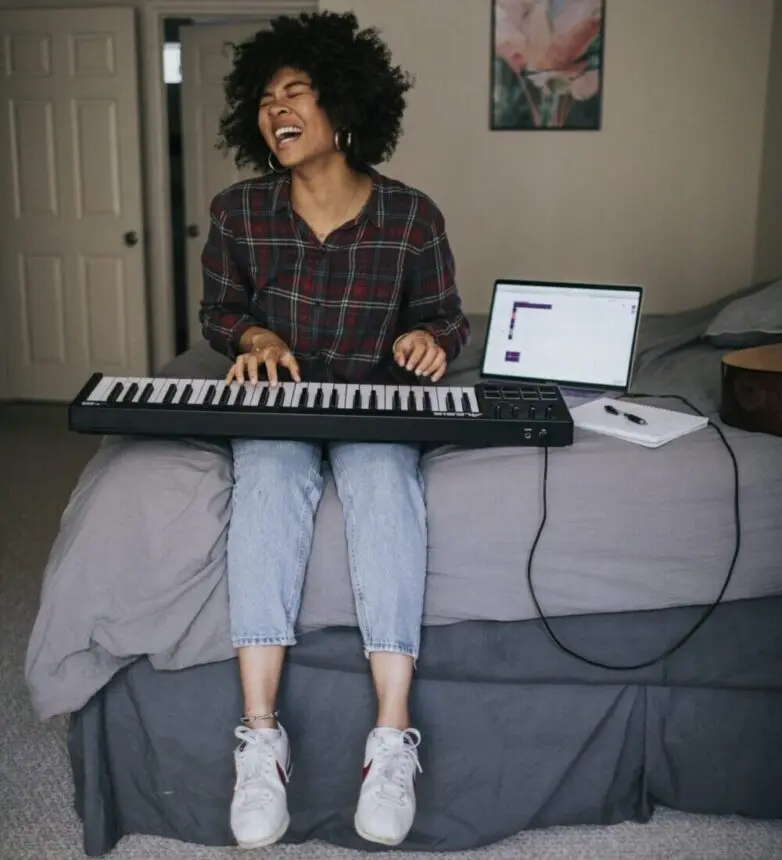 woman singing while sitting in her bed